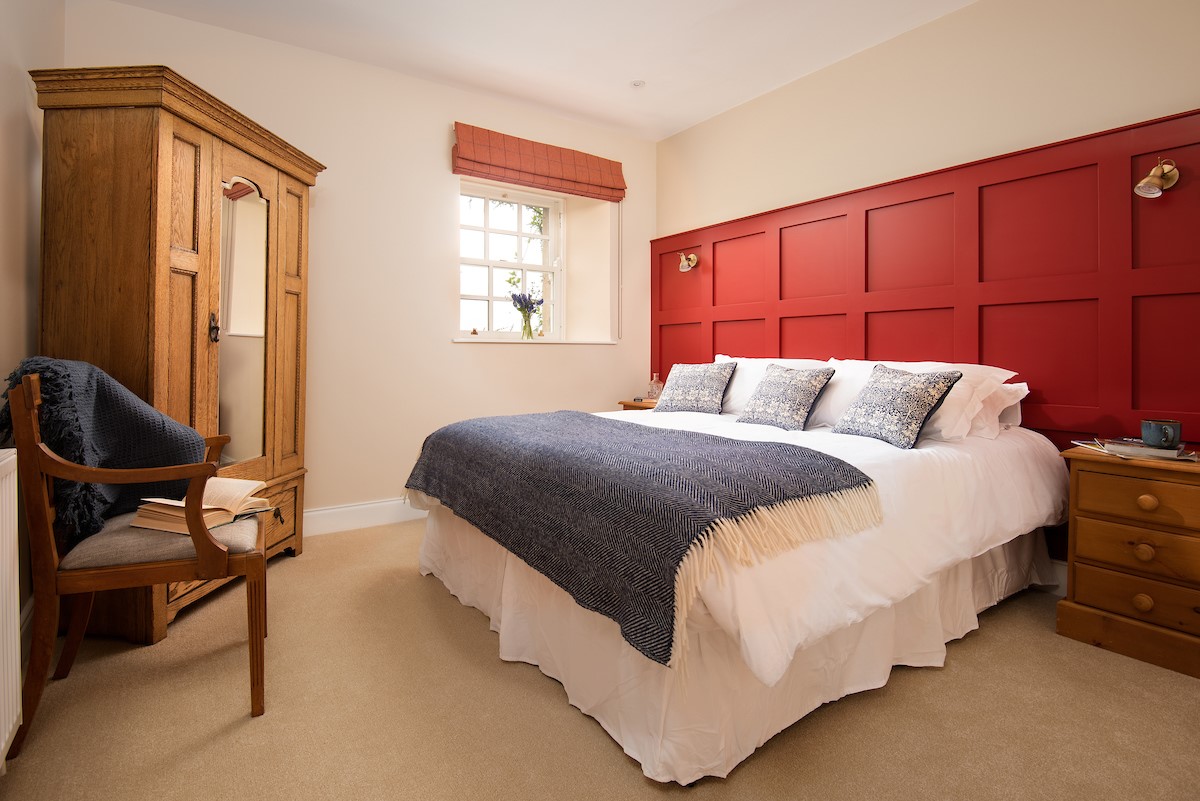 Fairnington East Wing - bedroom two with painted panelled wall which adds a pop of colour