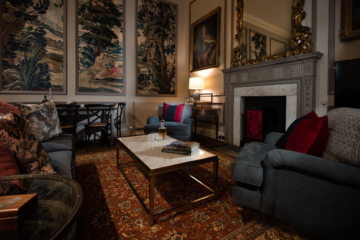 The Earl & Countess - sitting room with dramatic wall panels and soft evening lighting