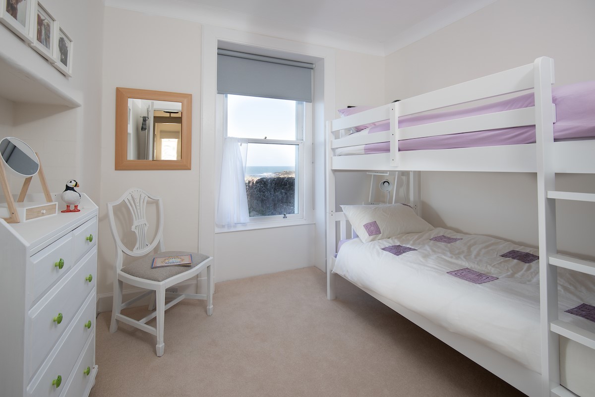 East Bay Beach House - bedroom three with bunk beds, sea views and chest of drawers
