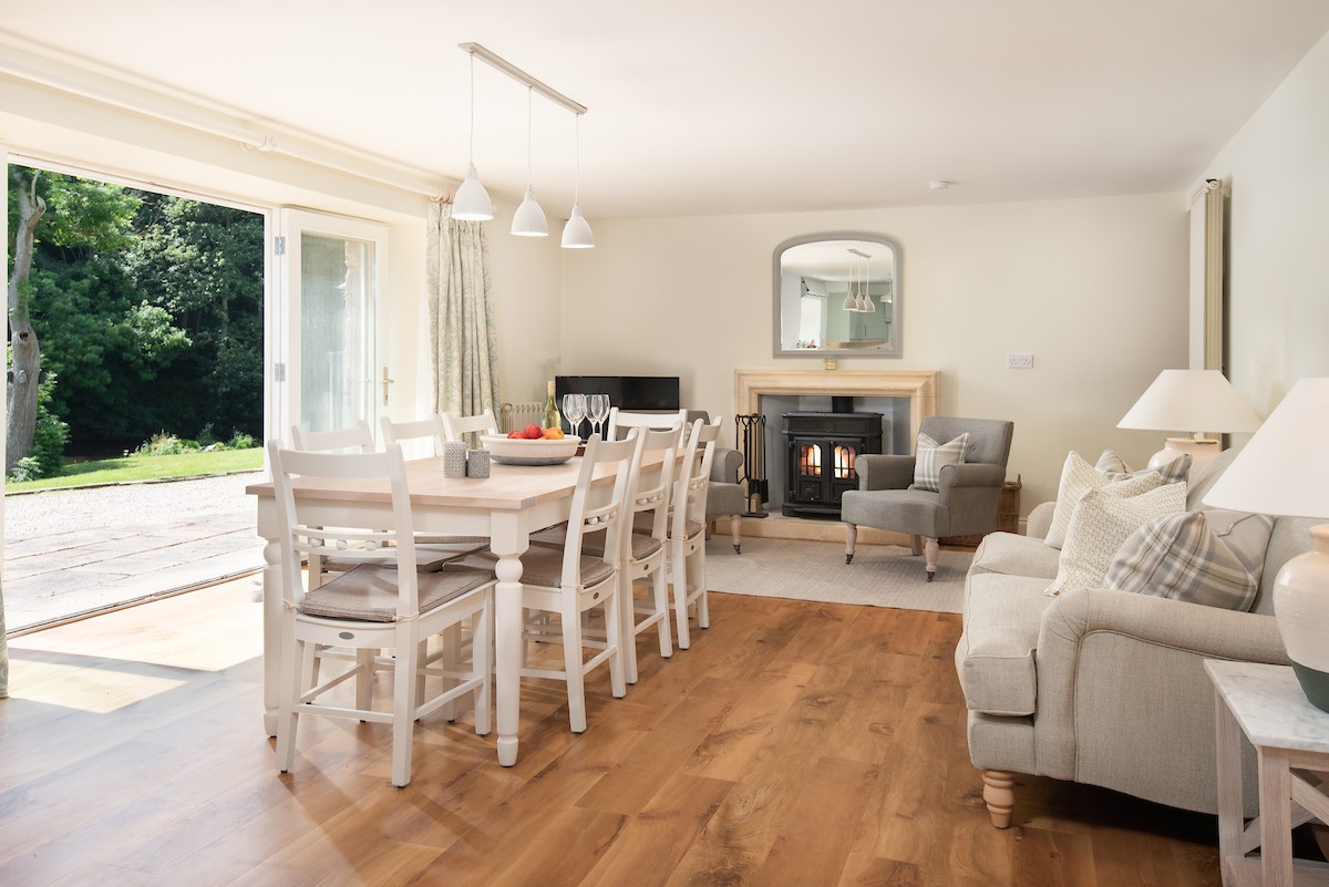Open plan dining area with snug and large wood burner