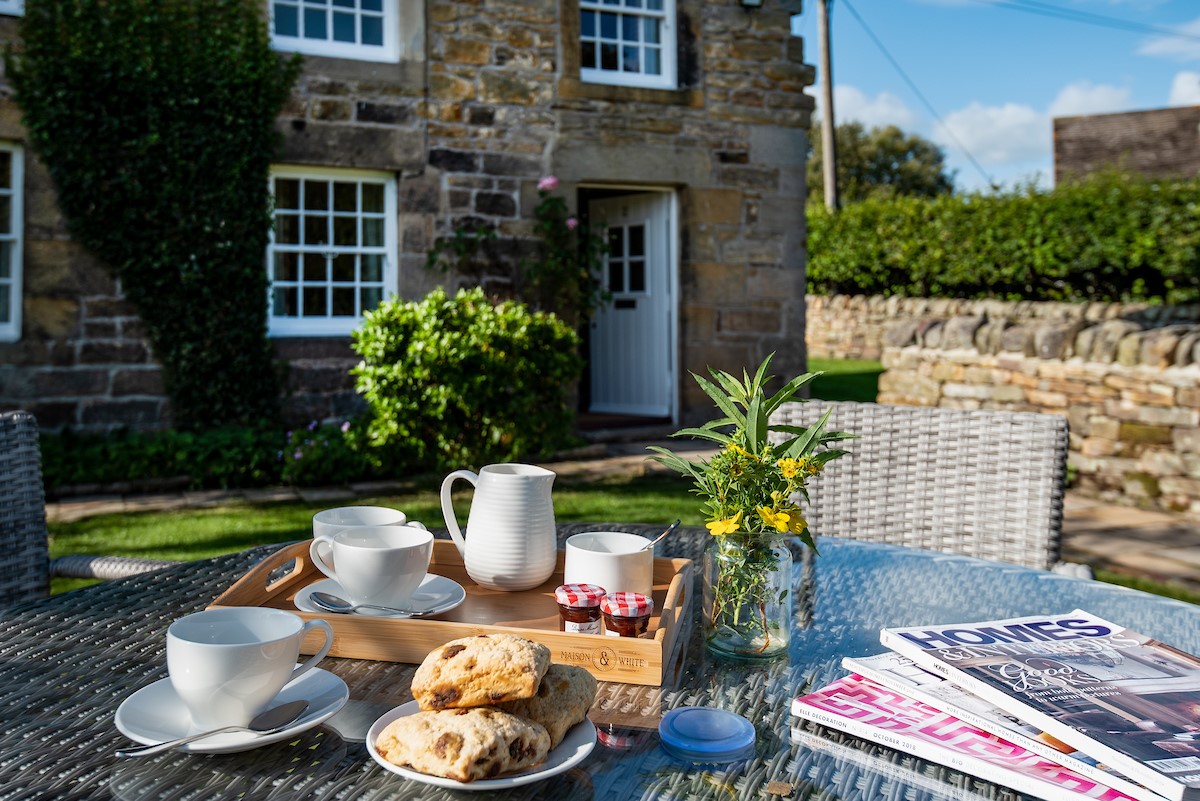 Aydon Castle Cottage - enjoy a cup of tea and a magazine in the sunny front garden