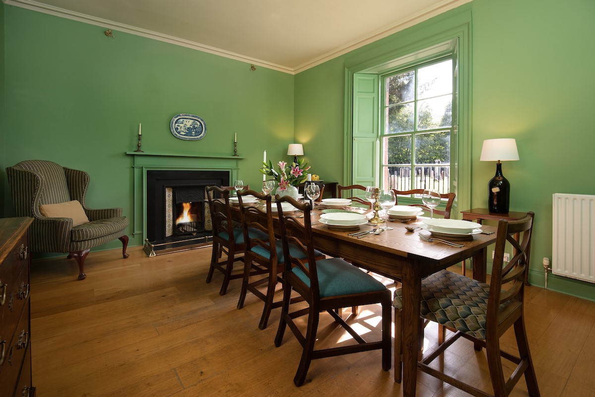 Cloister House - dining table with seating for eight guests and open fire