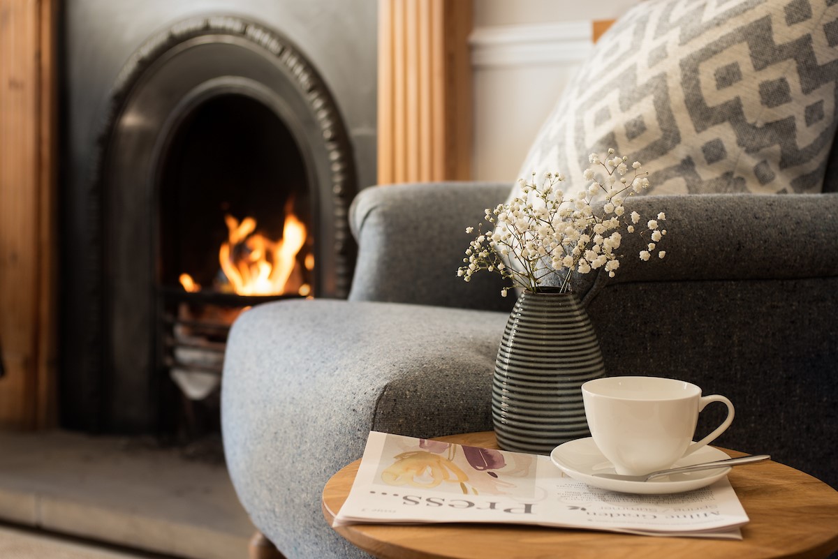 Tweedside - a cosy armchair in front of an open fire