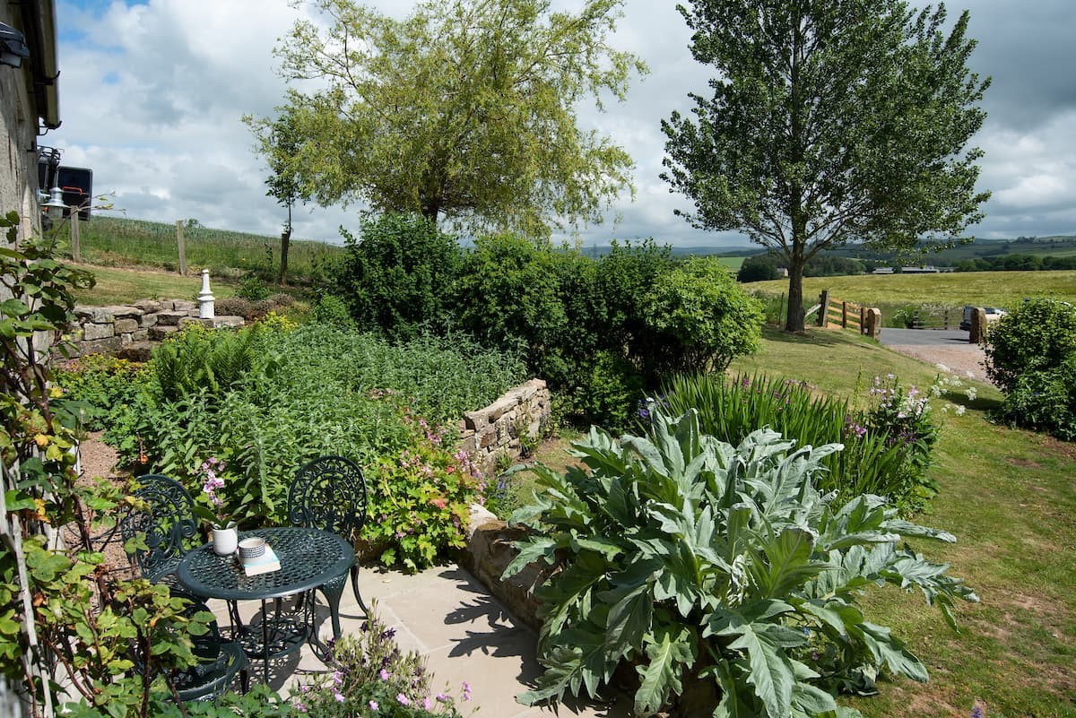 Poppy House - the charming gardens to the front with views to the rolling Northumbrian countryside