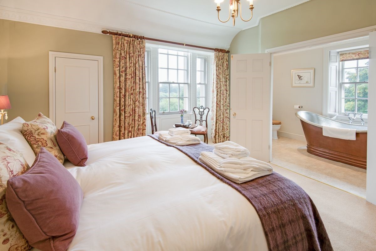 Abbey House - bedroom one with en suite bathroom and stunning river views