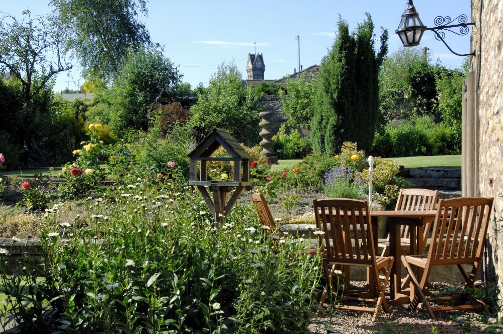 Abbey House - the garden with outside seating and lots of beautiful plants