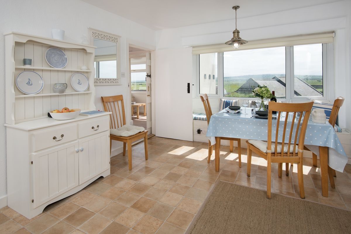 Beachcomber Cottage - dining area with Welsh dresser and coastal views