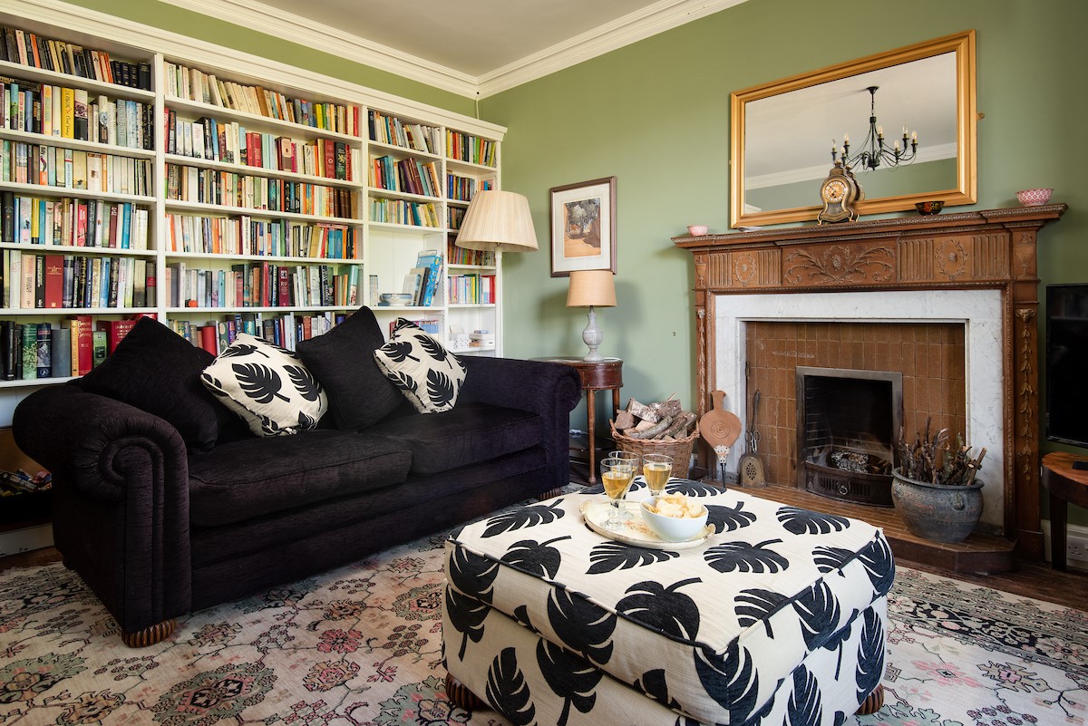 Mossfennan House - cosy ground floor snug with open fire and a large selection of books