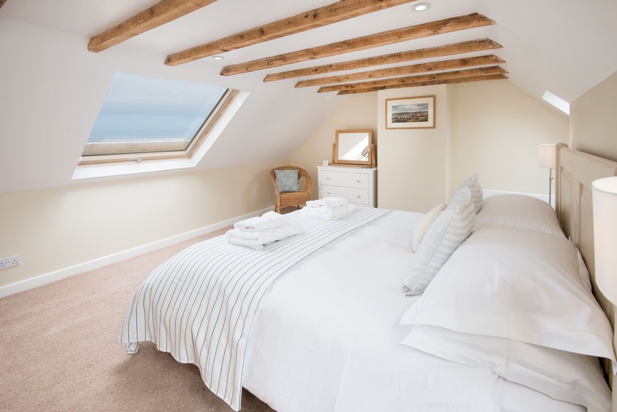 Beachcomber Cottage - bedroom one with super king bed and sea views