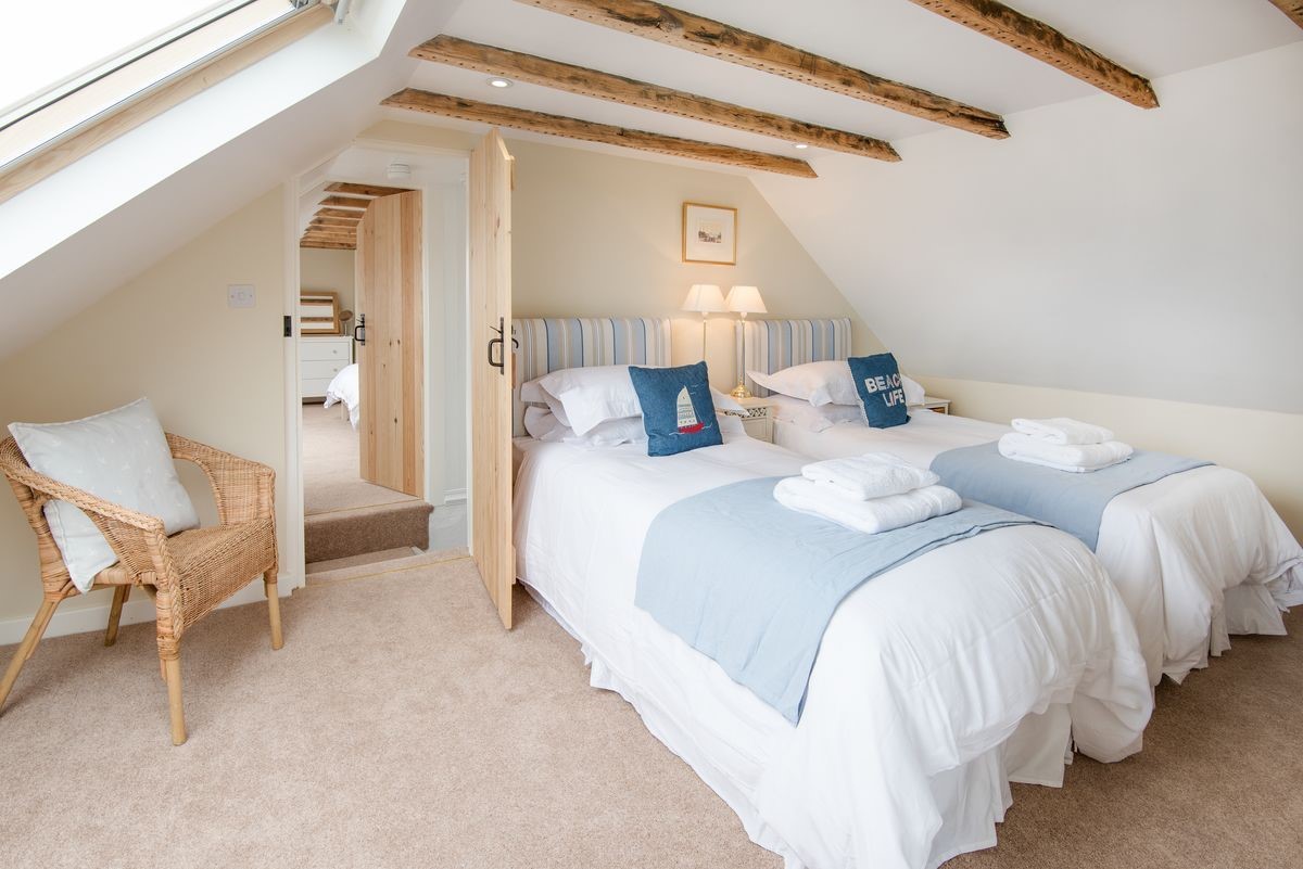 Beachcomber Cottage - bedroom two with twin beds and coastal themed furnishings