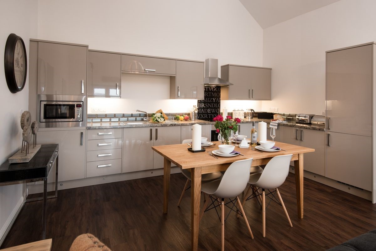 Byre - sleek kitchen and dining area with seating for four guests