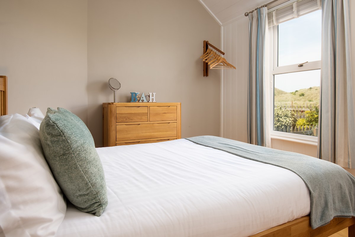 Driftwood Bamburgh - bedroom one with king size double bed and views out to the dunes