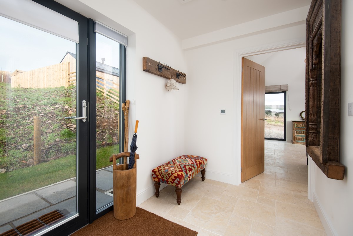 The Elm -  entrance door from the rear of the property into the spacious hallway with bench seating, coat hooks and umbrella stand
