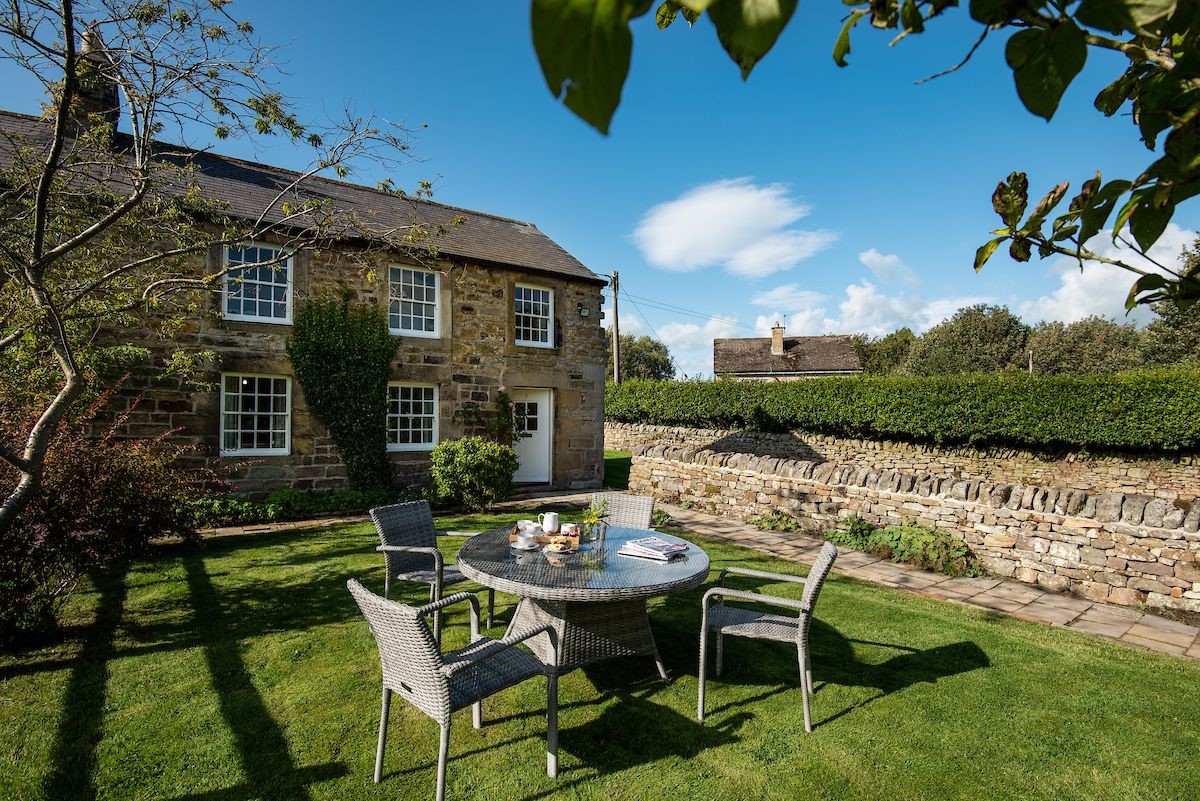 Aydon Castle Cottage - the front garden with outside furniture