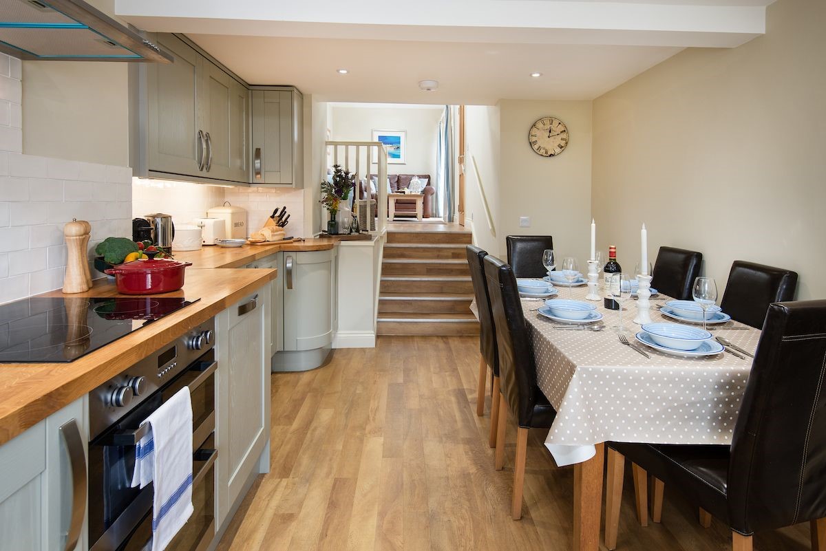 Crosslea - kitchen with dining area and steps leading up to the snug