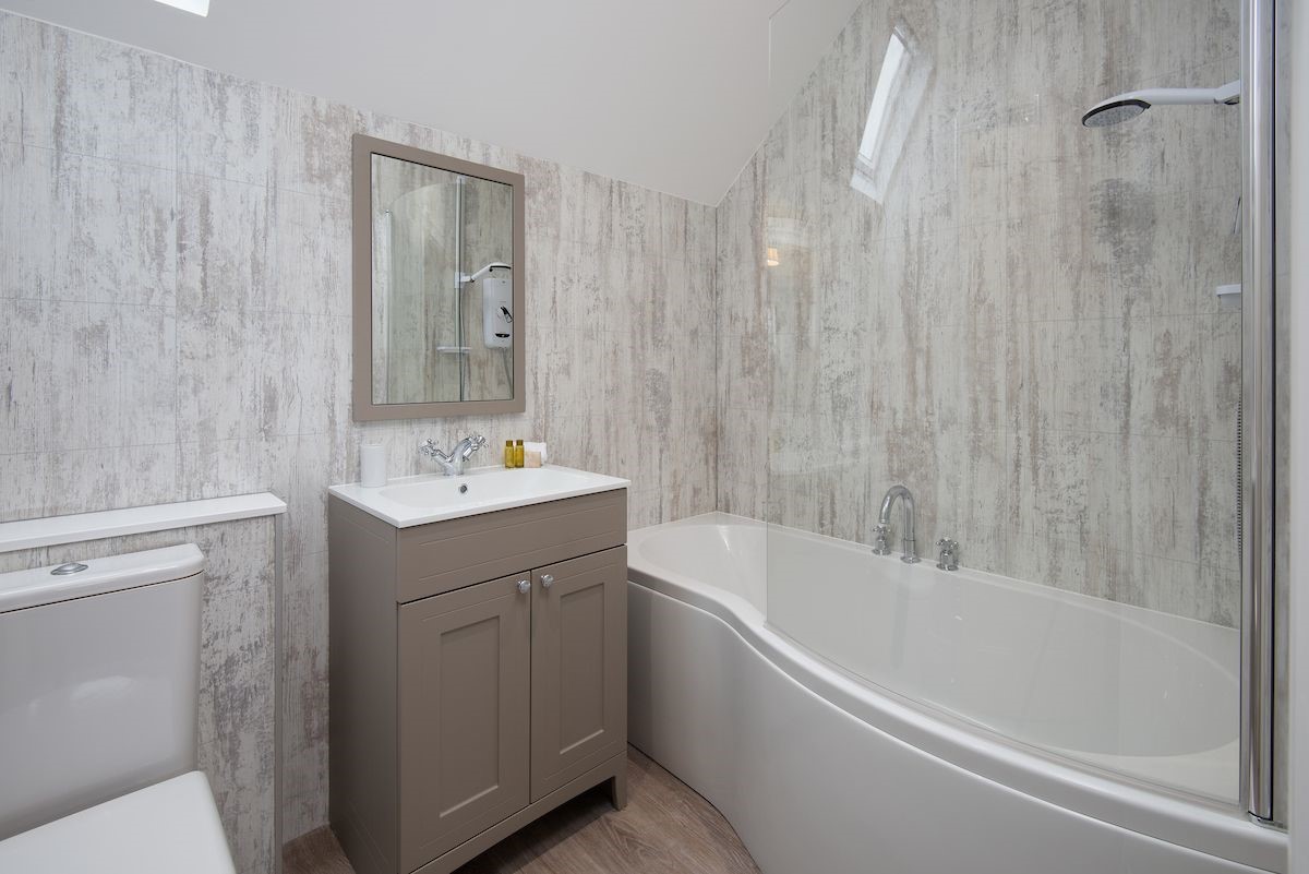 Crosslea - family bathroom on the first floor with bath and shower over, WC and basin