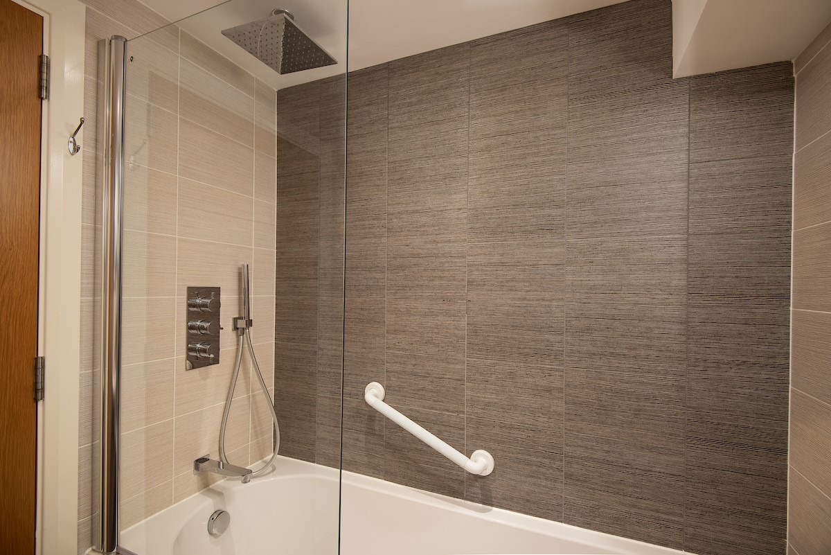 The Barley Loft - en-suite bathroom containing bath with rainforest shower over and separate showerhead attachment