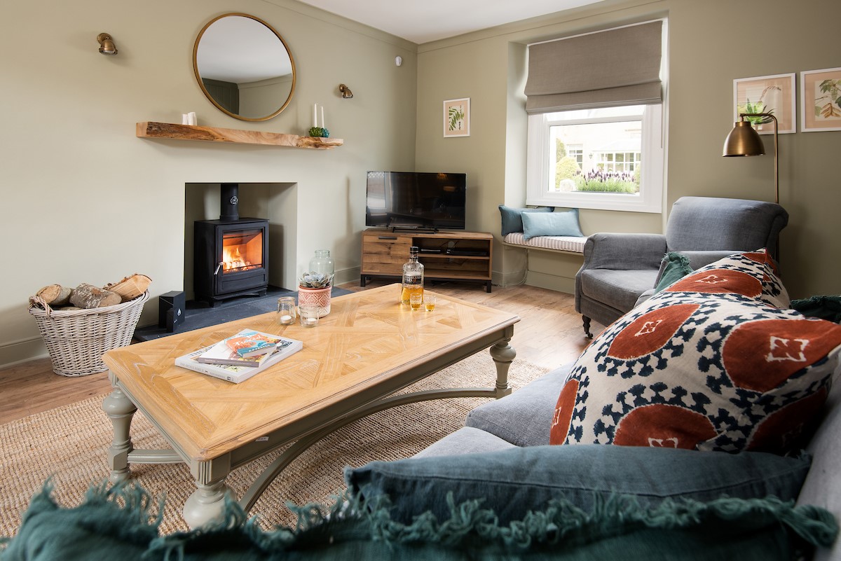 Campsie Cottage - the fire-warmed sitting room is a cosy space to relax with a dram and a classic film