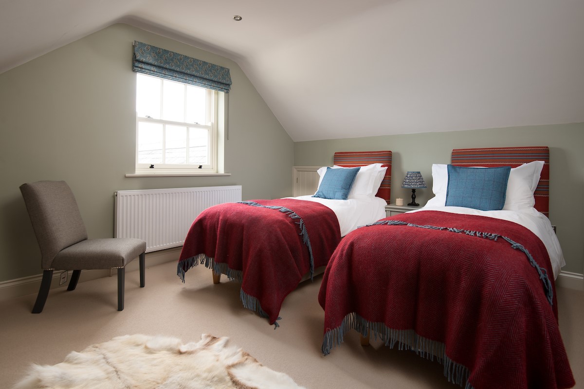 Risingham Cottage - bedroom four with king size bed that can be split into twins