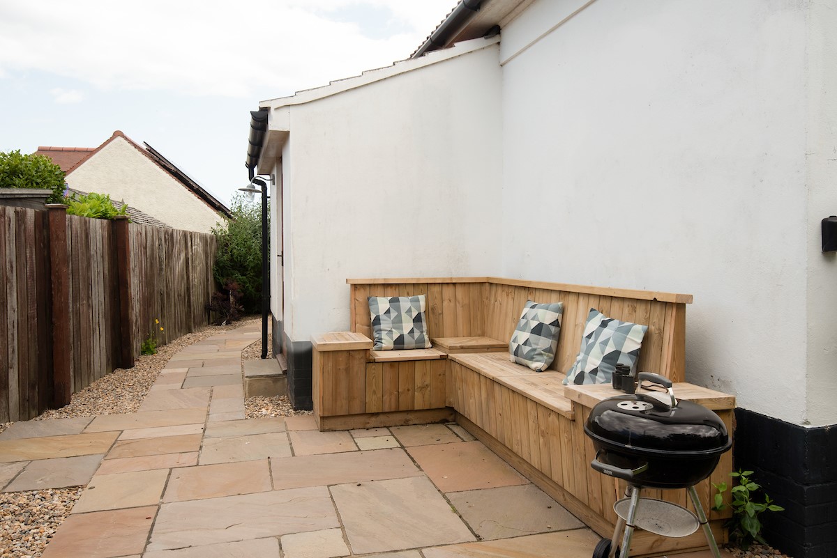 The Tumblers - patio with corner bench seating and barbecue