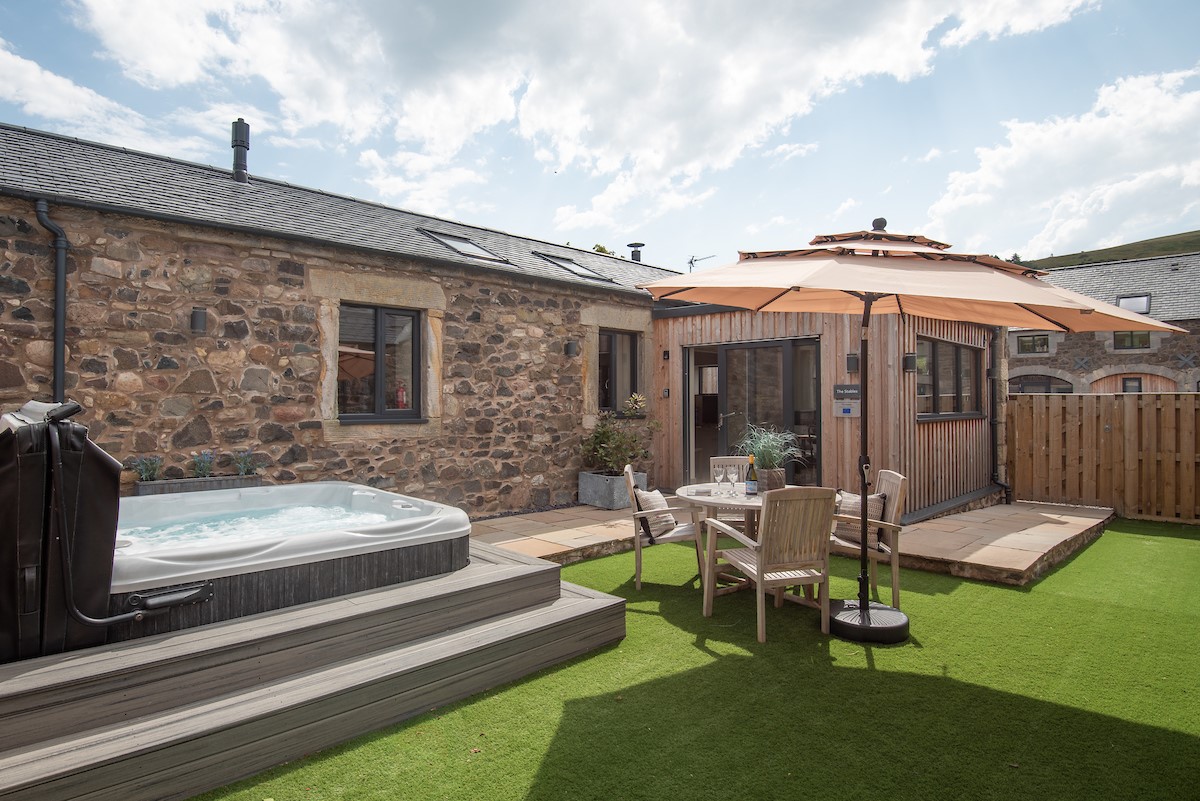The Stables at West Moneylaws - garden with hot tub and outdoor dining furniture