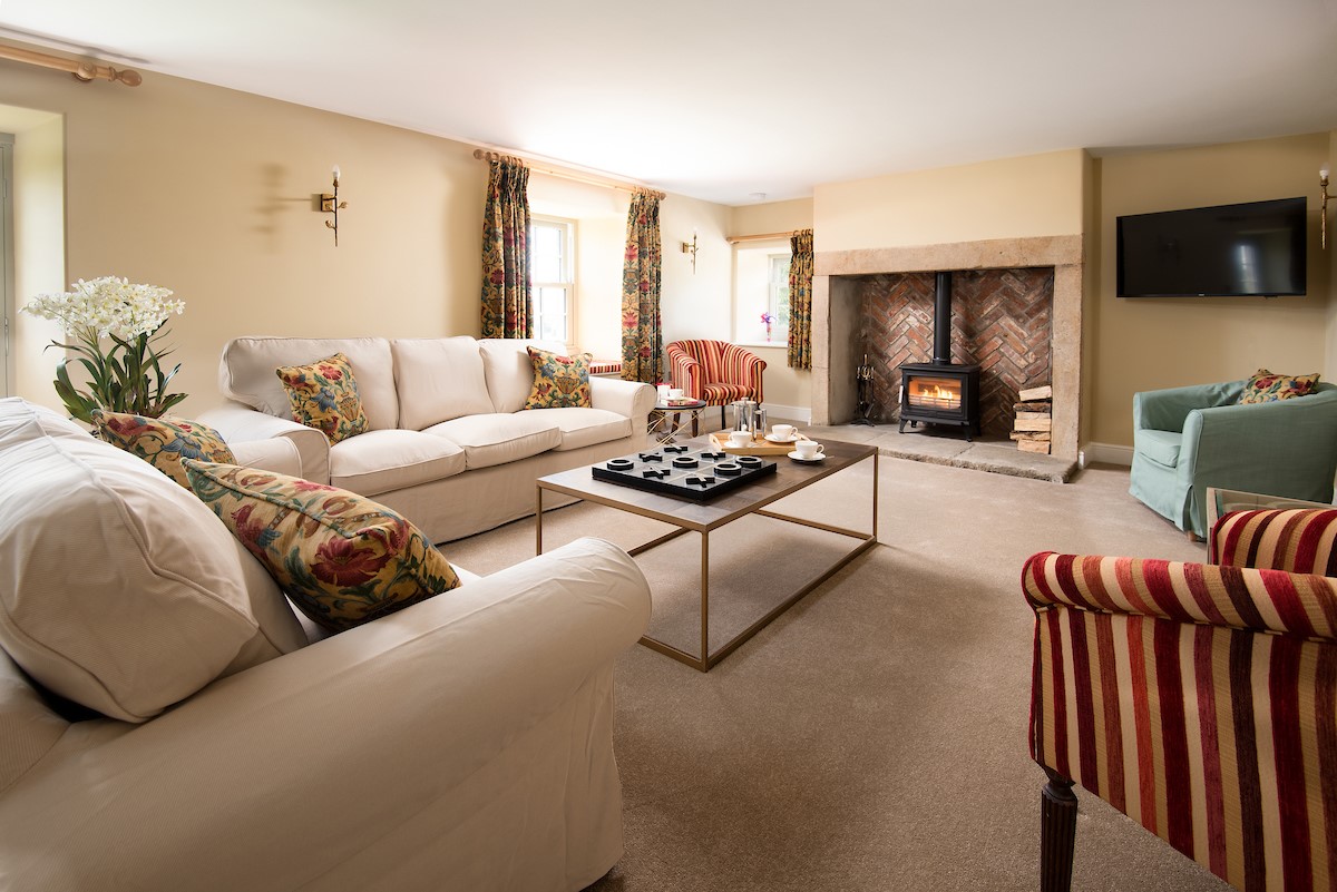 Shepherd's House - drawing room with comfortable seating and wood burning stove