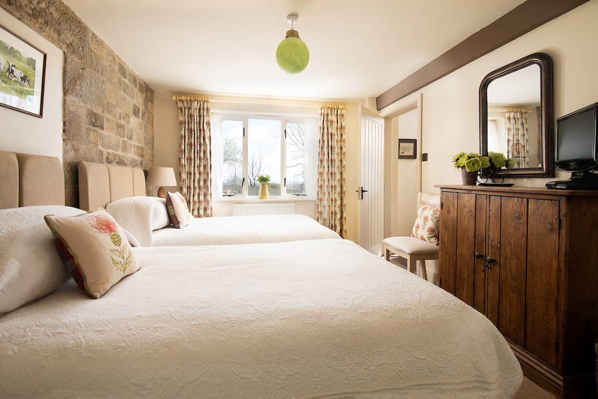 Anvil Cottage - the ground floor bedroom with the characterful exposed stone wall
