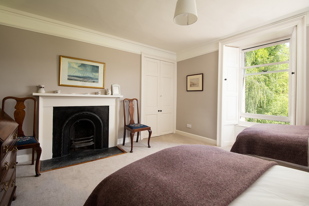 Mossfennan House - bedroom three with twin beds and decorative fireplace