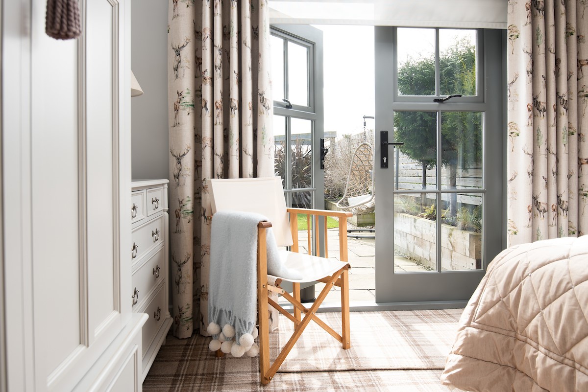 Number Nine, Lanchester - the French doors to the garden from the ground floor bedroom