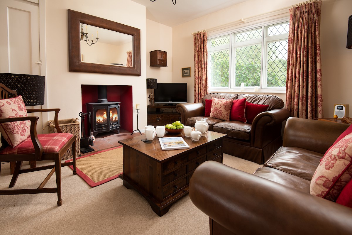 Kilham Cottage - cosy sitting room with two Laura Ashley sofas