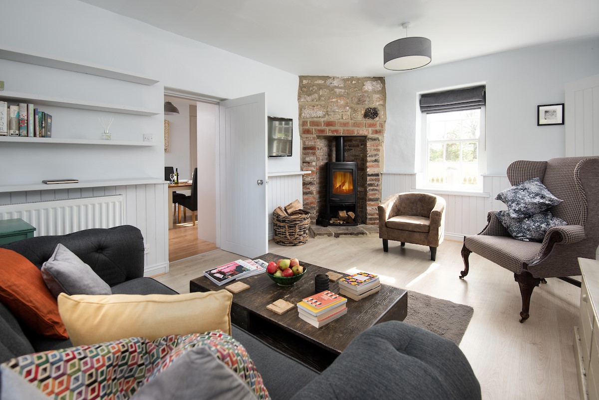 Blakey House - bright welcoming sitting room with cosy wood burner