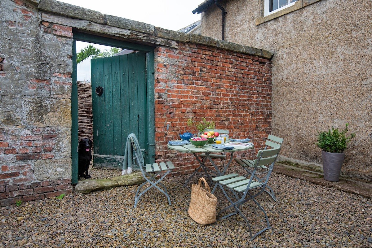 Mullins House - gravelled dining area with seating for 4 guests