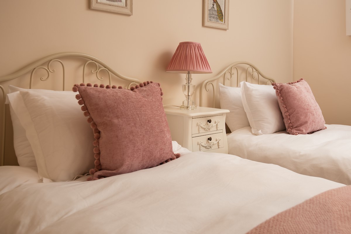 Kilham Cottage - twin beds in bedroom two with bedside table and lamp