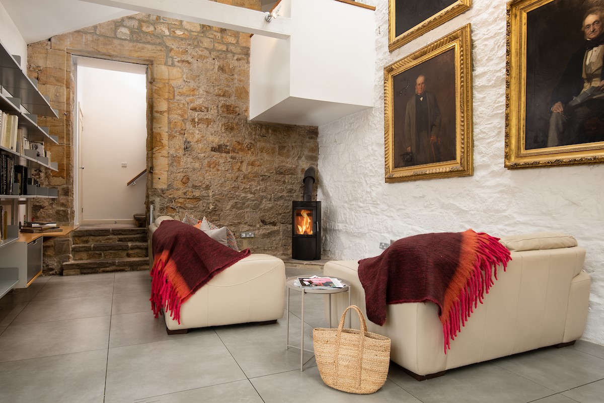 The Stables - modern log burning stove in the seating corner of the open plan kitchen