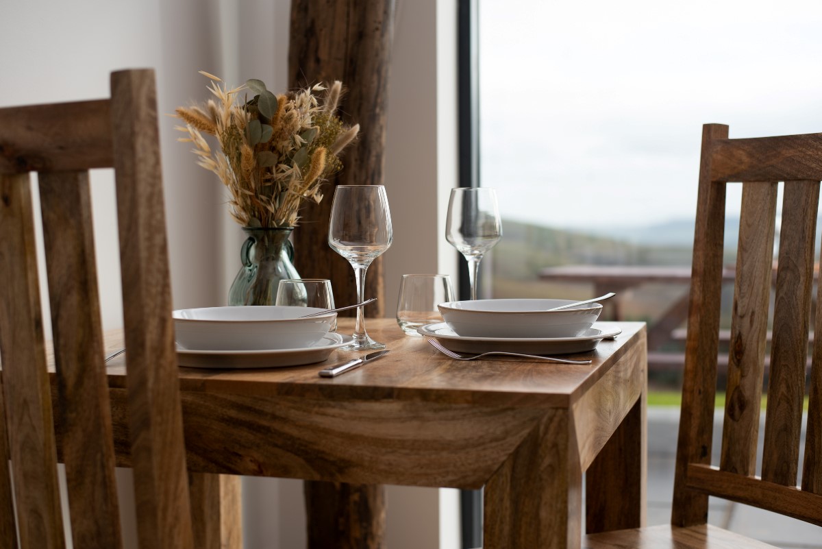 The Elm - dining area with wooden dining table and seating for two