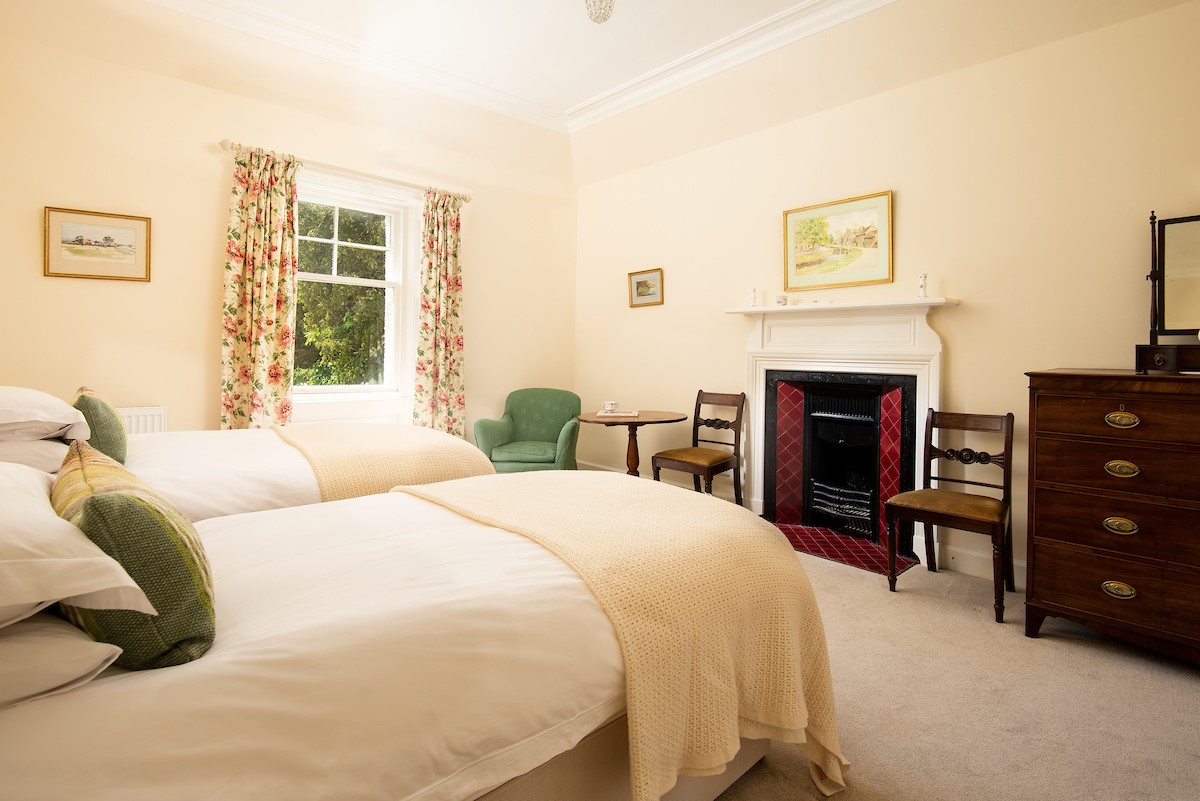 Mossfennan House - twin beds and decorative fireplace in bedroom four