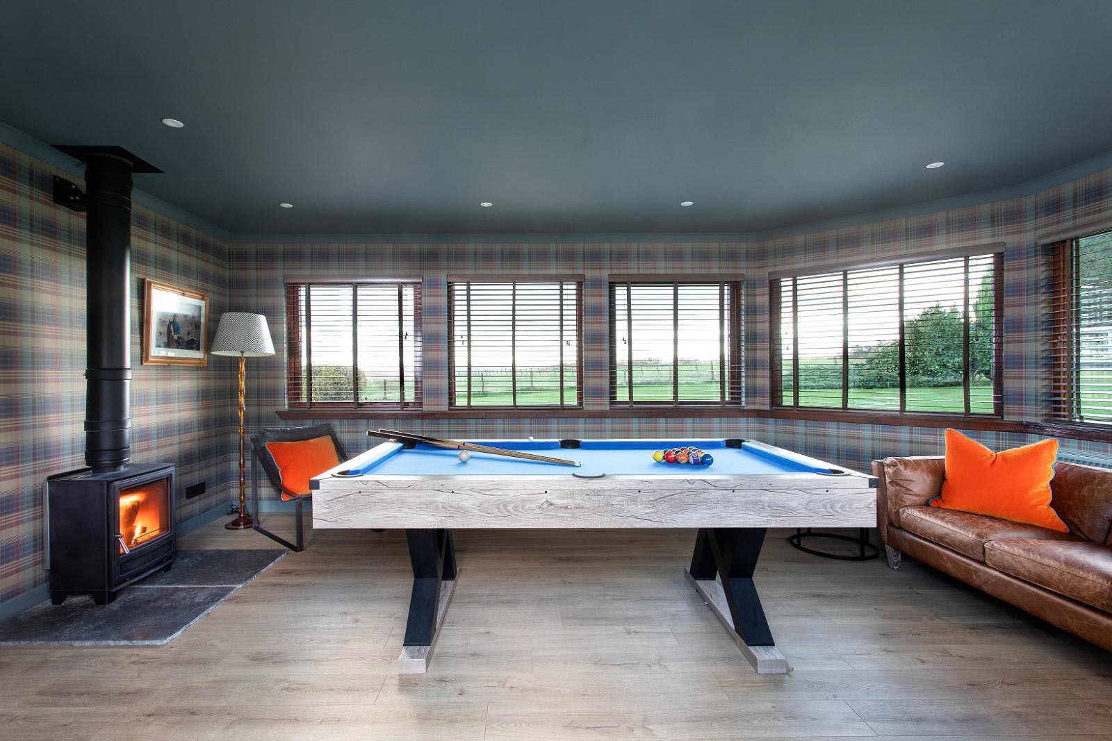Overthickside - cosy games room with pool table, comfortable seating and wood burner