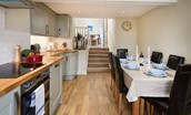 Crosslea - kitchen with dining area and steps leading up to the snug