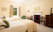 Mossfennan House - twin beds and decorative fireplace in bedroom four
