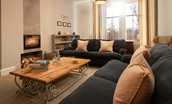 Cambridge House - the sitting room with wood burning stove and two large sofas