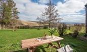 The School House - outdoor dining area in the shared garden with views of the rolling Upper Coquet valley