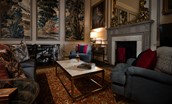 The Earl & Countess - sitting room with dramatic wall panels and soft evening lighting