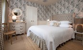 West Lodge - bedroom with wallpaper from designer Angie Lewin