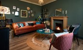 Mulberry Cottage - sitting room with open fire and large double sofa
