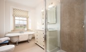 Broadgate House - bedroom three en-suite bathroom with roll-top bath, WC, basin and walk-in shower