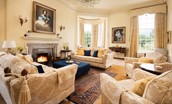 Fairnilee House - drawing room with ample seating around the open log fire
