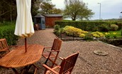 Bughtrig Cottage - the outside seating area with views over the pretty garden