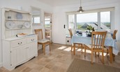 Beachcomber Cottage - dining area with Welsh dresser and coastal views