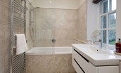Chaffinch Cottage - family bathroom with bath and shower over, towel rail and basin