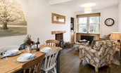 Chestnut Cottage - open-plan sitting room with dining area and wood burning stove
